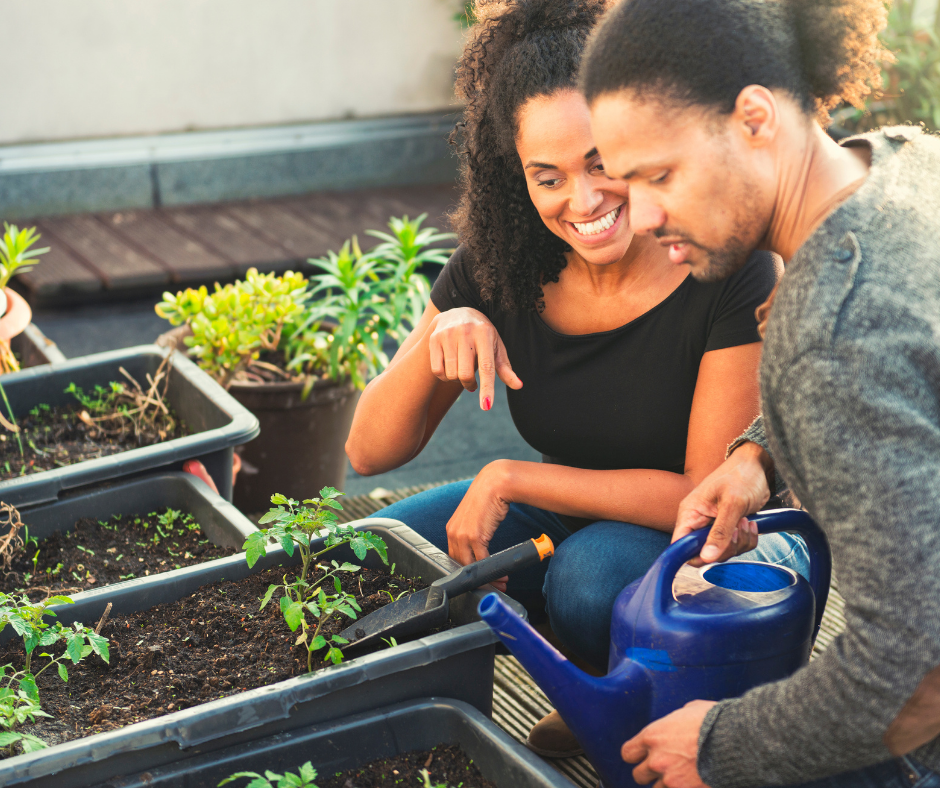 A young couple gardening on a rooftop