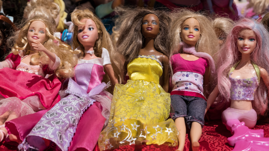 A range of multiethnic barbie toy dolls with fancy dresses in a memorabilia store display