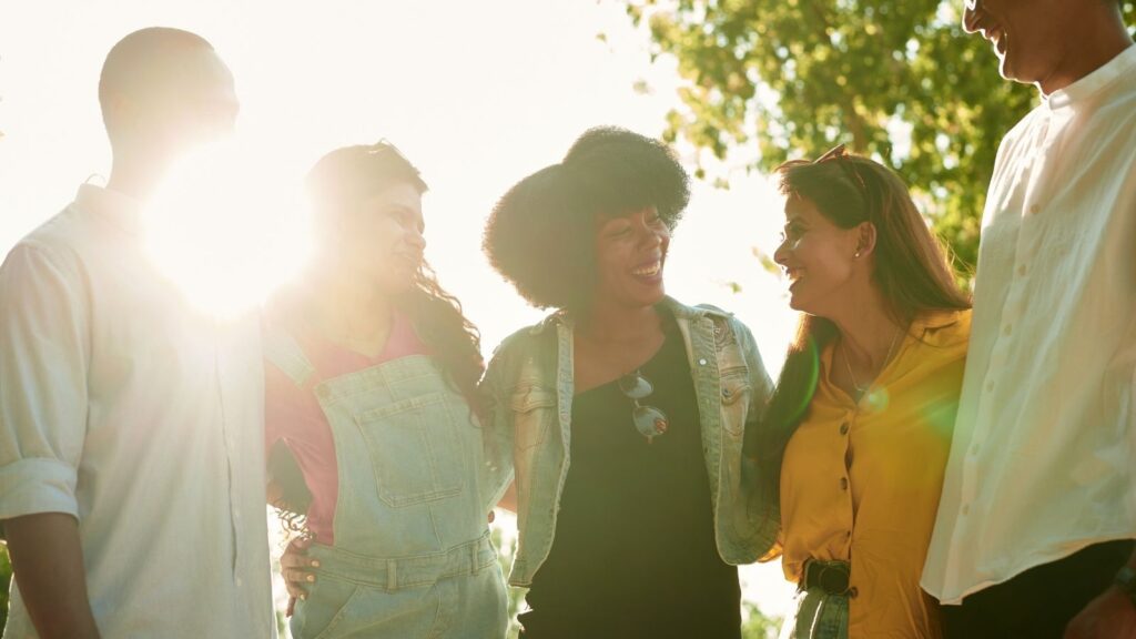 a group of different people standing together smiling and talking—a glimmer of hope for a more tolerant world