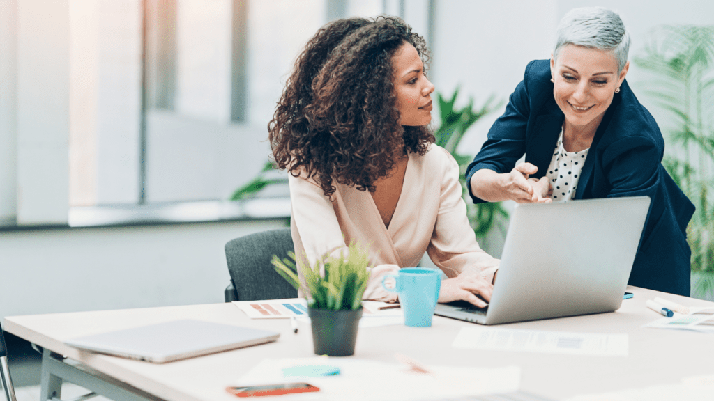 Two women working and supporting each other in the technology industry