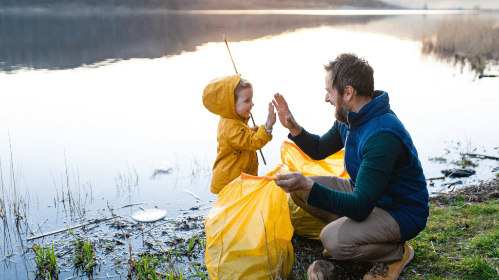 Father and child working together to clean up the local natural environment.