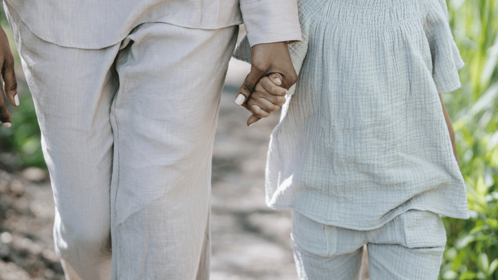 A mother and daughter walking hand in hand