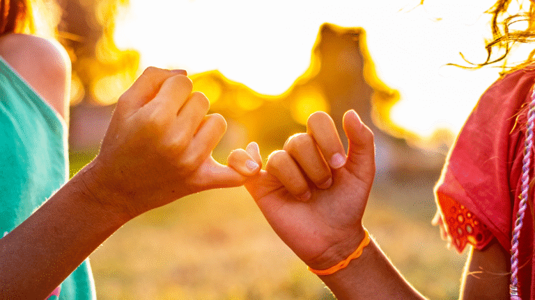 Close up girls showing reconciliation with hands in nature